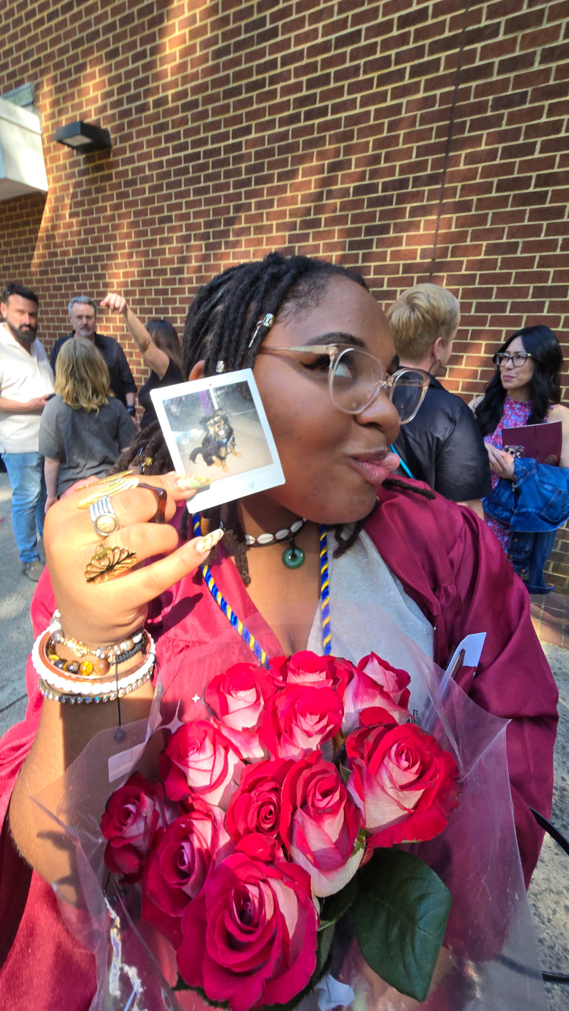 Lanaia on her Oakton graduation day holding roses